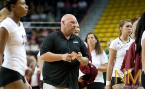 NMSU head coach Mike Jordan prepares to talk to his team before the second set