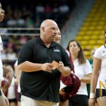 NMSU head coach Mike Jordan prepares to talk to his team before the second set