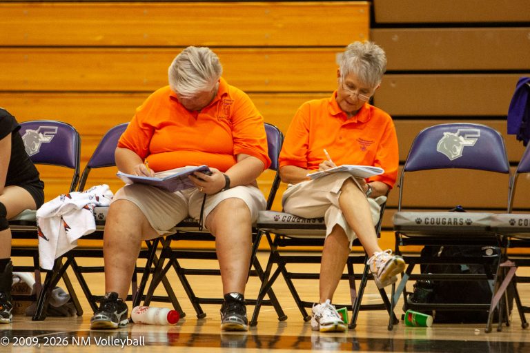 Flo Valdez and her assistant seated on the bench doing paperwork.